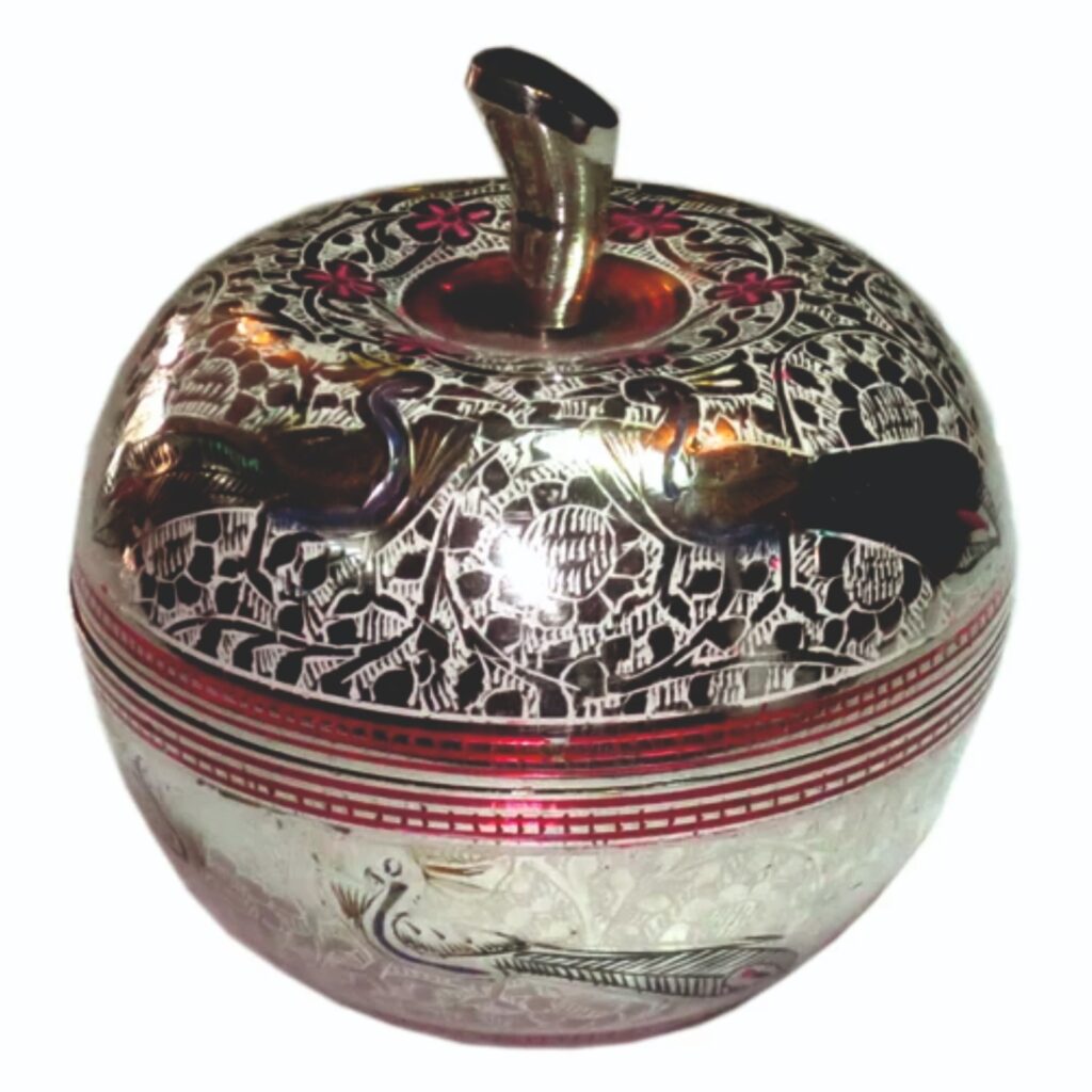 Image shows a decorative brass metal apple