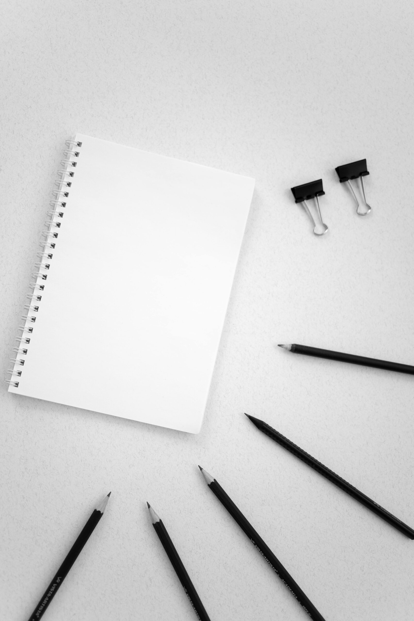 Image of stationery items like notepad, pencils, pens, u-clips
