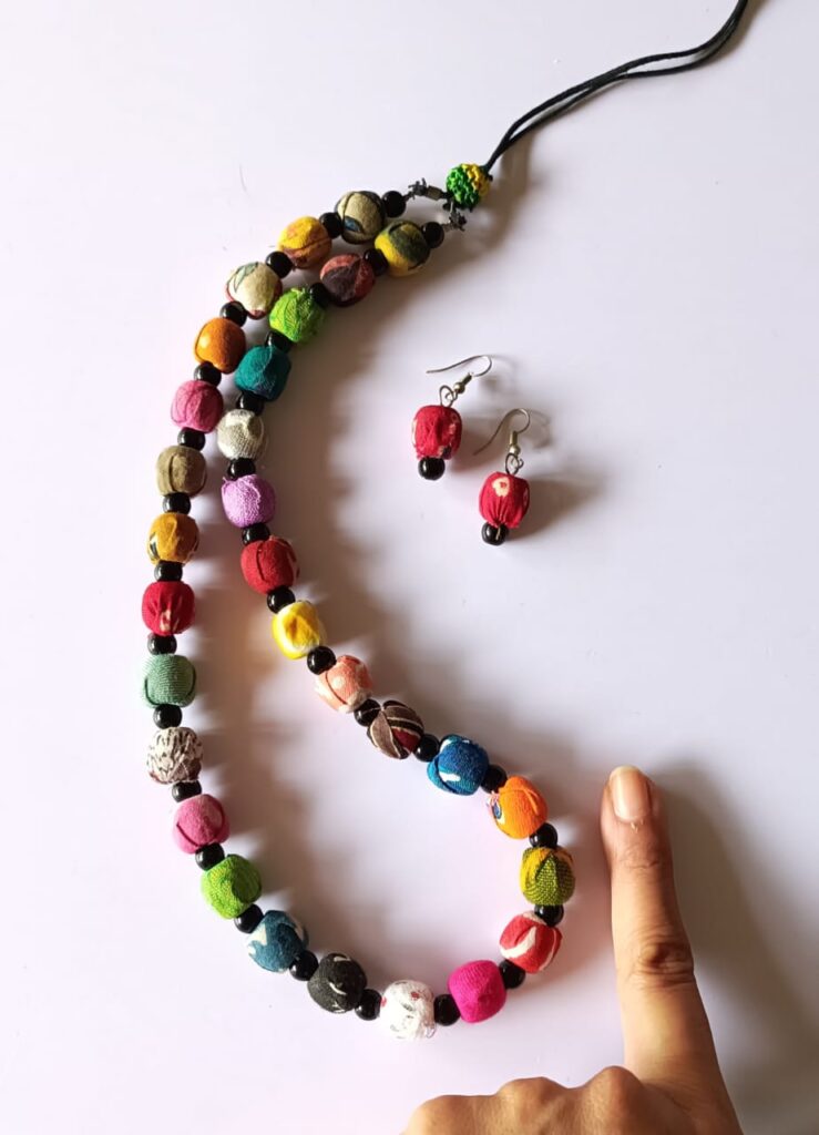 Image shows Handmade necklace set with cloth beads