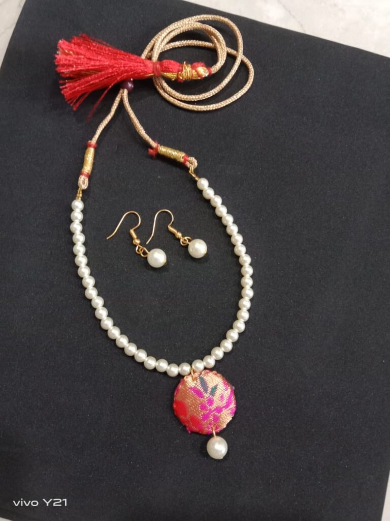 Image shows Handmade necklace set with white pearl and paithani cloth pendant
