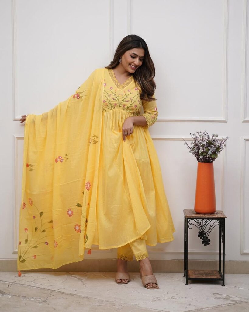 Image shows a model wearing YELLOW COTTON KURTI WITH PINK EMBROIDERY