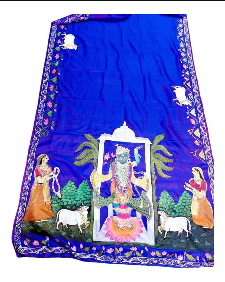 Image shows a handpainted pichwai silk saree in vibrant blue