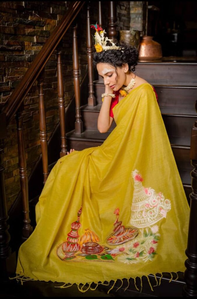 Image shows hand-painted wearable art saree in yellow colour.